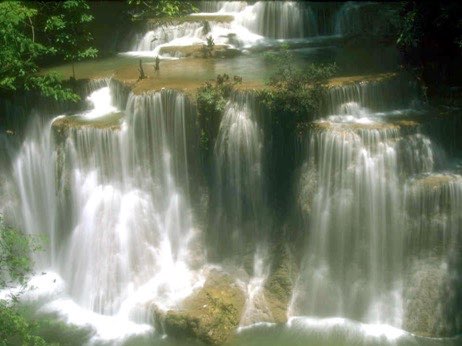 A waterfall with lots of water falling down it.